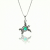 Small Turtle Pendant featuring a charming design, this pendant is adorned with a 5mm polished green stone that adds a touch of sparkle. It comes with an 18" .7mm sterling silver box chain, ensuring it’s ready to wear right away.