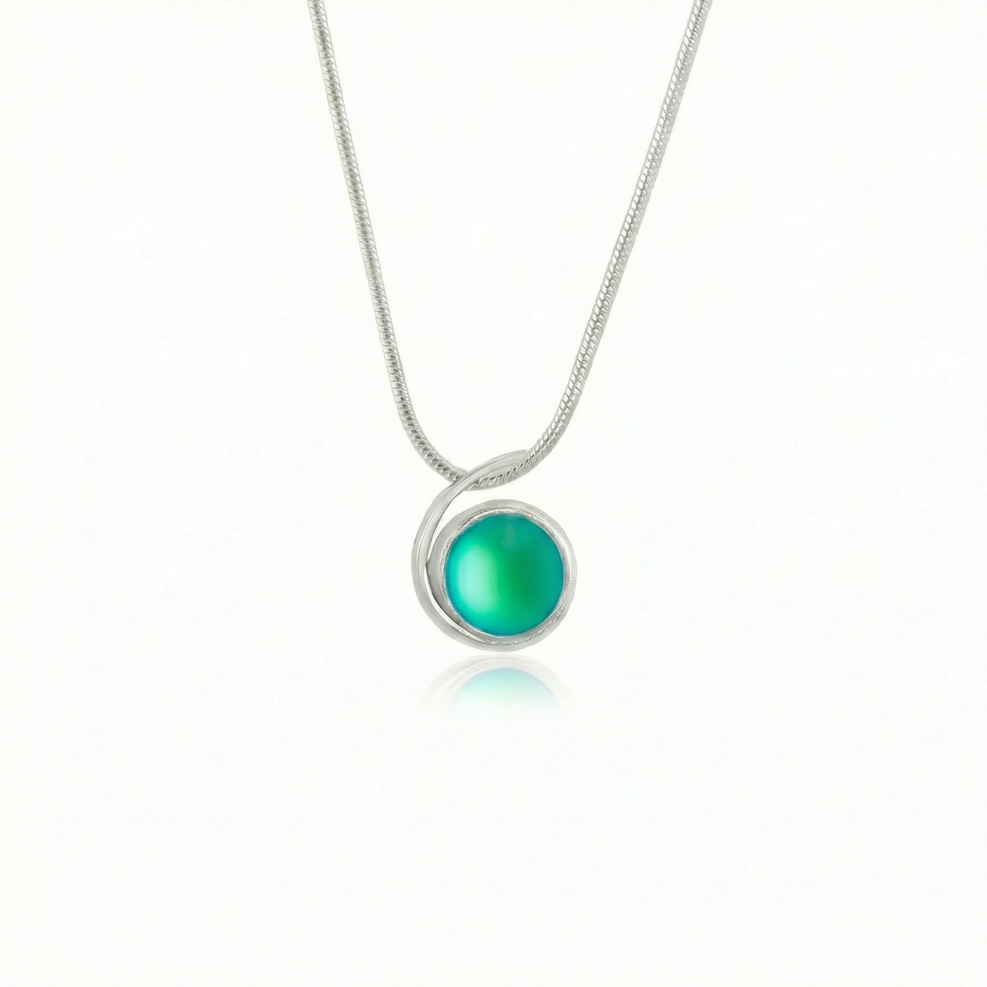 Small Wave Pendant, where it represents the "O" of Ocean Beach, while the surrounding silver symbolizes the "B." The pendant comes with a 1mm sterling silver snake chain, 18" long, with a frosted green stone.
