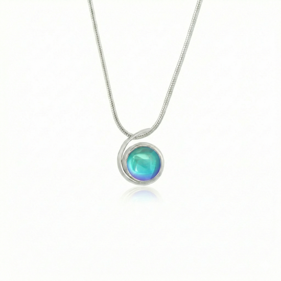 Small Wave Pendant, where it represents the "O" of Ocean Beach, while the surrounding silver symbolizes the "B." The pendant comes with a 1mm sterling silver snake chain, 18" long, with a polished aqua stone.
