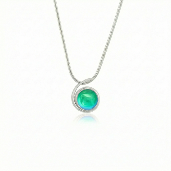 Small Wave Pendant, where it represents the "O" of Ocean Beach, while the surrounding silver symbolizes the "B." The pendant comes with a 1mm sterling silver snake chain, 18" long, with a polished green stone.