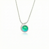 Small Wave Pendant, where it represents the "O" of Ocean Beach, while the surrounding silver symbolizes the "B." The pendant comes with a 1mm sterling silver snake chain, 18" long, with a polished green stone.