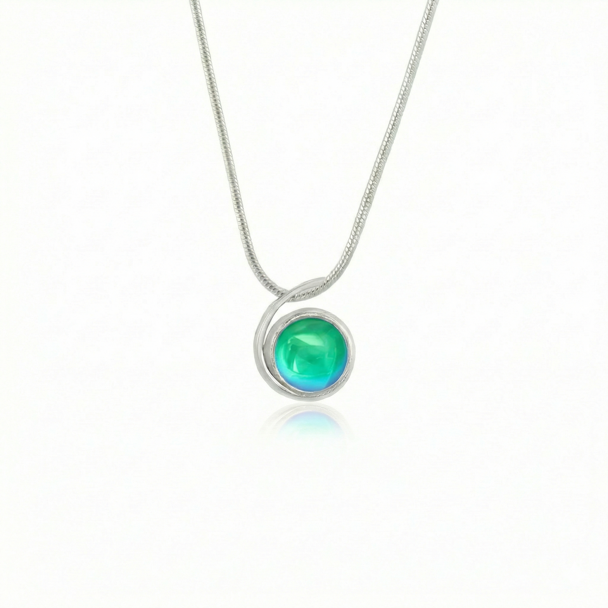 Small Wave Pendant, where it represents the "O" of Ocean Beach, while the surrounding silver symbolizes the "B." The pendant comes with a 1mm sterling silver snake chain, 18" long, with a polished green stone.