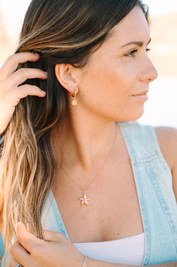 Sunburst Crystal Earrings, a dazzling pair that radiates elegance and brilliance. Inspired by the radiant energy of the sun, these earrings feature a central crystal surrounded by smaller crystals, creating a stunning sunburst effect that catches the light from every angle.