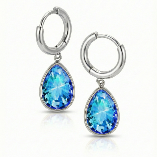 Teardrop Crystal Earrings are meticulously crafted to catch the light and add a dash of elegance with 9 mm blue stone and 11mm diameter silver stainless hoop.