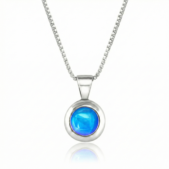 Teeny Tiny Pendant crafted with a thick silver bezel and featuring a stunning 5mm glowing polished blue stone. The pendant comes complete with an 18" sterling silver box chain.