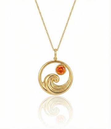 Gold featuring a minimalist ocean wave charm with a fire gemstone on a delicate chain