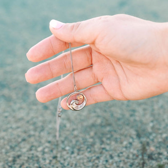 Suspended from an adjustable 16"-18" chain, it sits perfectly at your desired length. Whether you're a surfer, beach enthusiast, or simply drawn to nautical vibes, this pendant brings a splash of maritime charm to your everyday look.