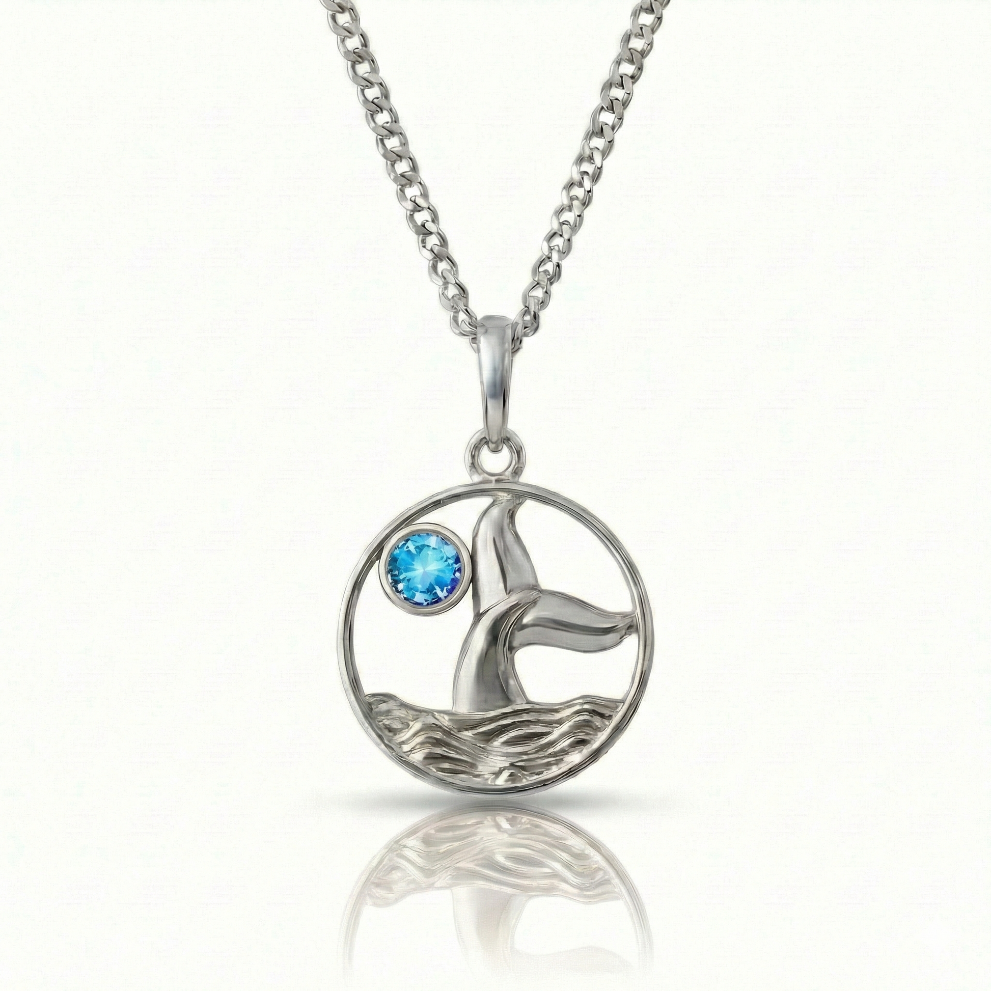 Whale tale pendant with silver stainless steel and a blue gemstone.