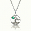 Whale tale pendant with silver stainless steel and a green gemstone.