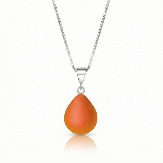 Our best selling crystal X-Small Drop Pendant is a beautiful, easy simple addition to any outfit. Handmade pendants come in a wide variety of colors and shine with an iridescent glow of color from within. Sterling silver .7mm box chain, 18" included with the frosted fire pendant.