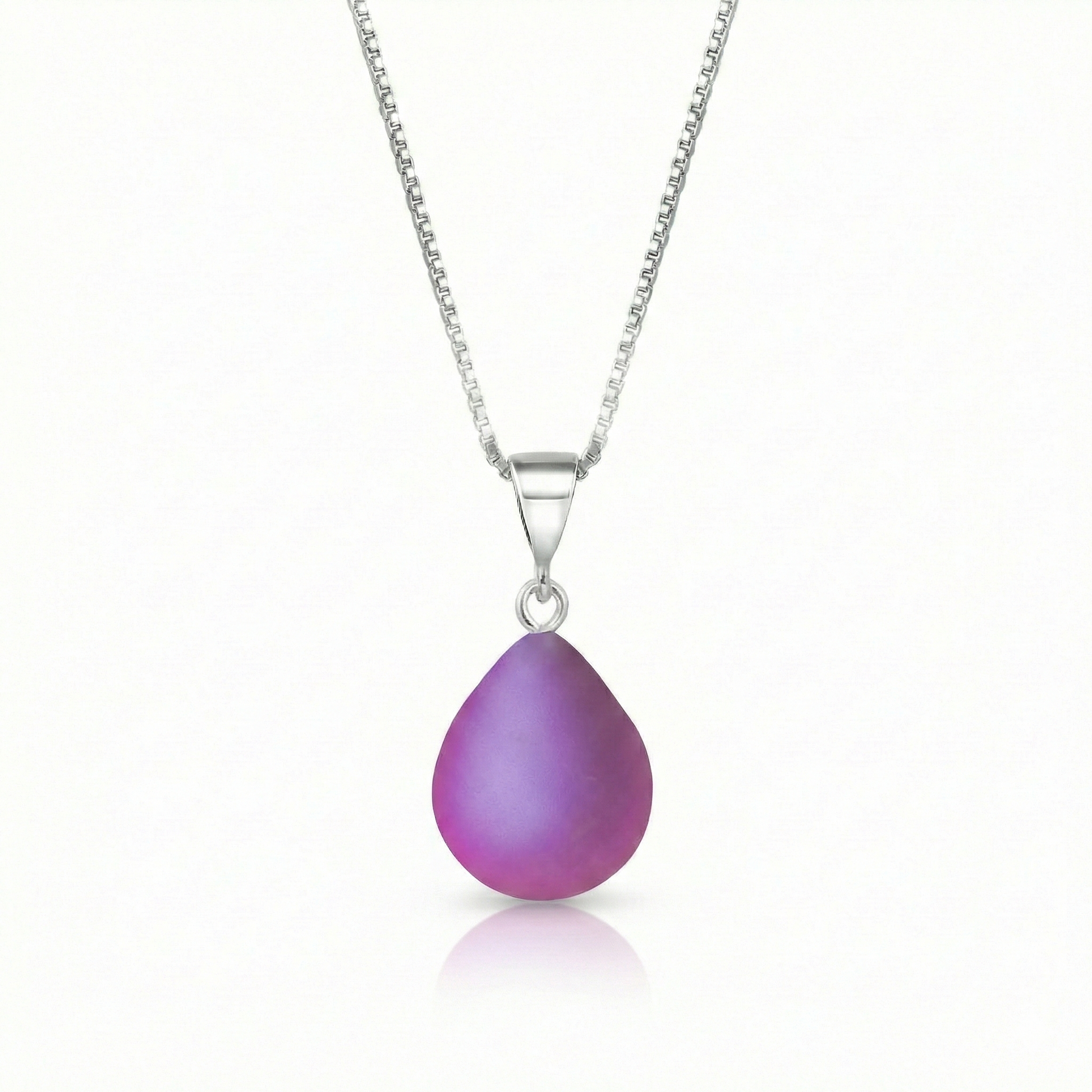 Our best selling crystal X-Small Drop Pendant is a beautiful, easy simple addition to any outfit. Handmade pendants come in a wide variety of colors and shine with an iridescent glow of color from within. Sterling silver .7mm box chain, 18" included with the frosted pink pendant.