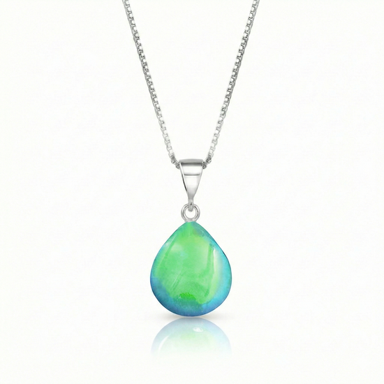 Our best selling crystal X-Small Drop Pendant is a beautiful, easy simple addition to any outfit. Handmade pendants come in a wide variety of colors and shine with an iridescent glow of color from within. Sterling silver .7mm box chain, 18" included with the polished green pendant.