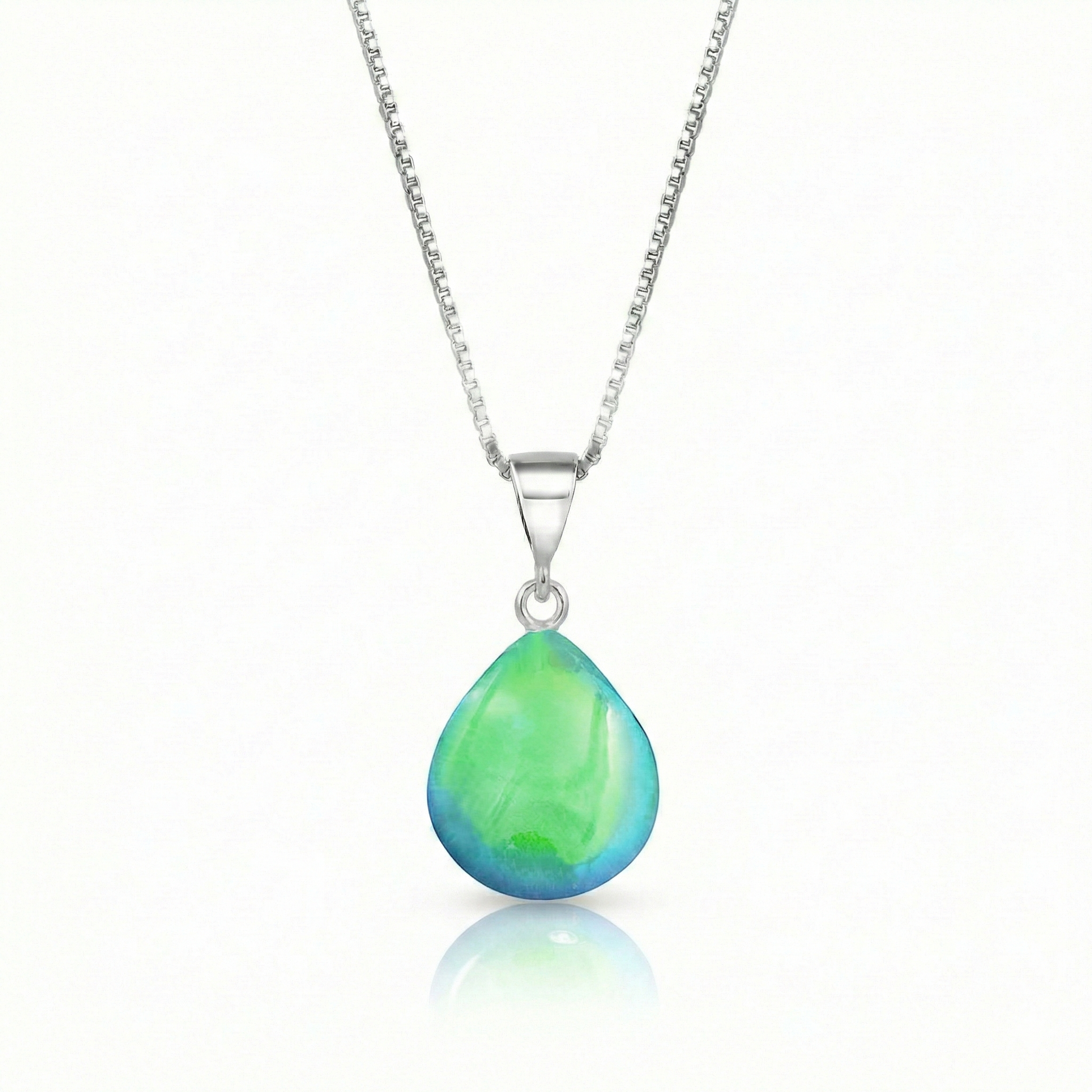 Our best selling crystal X-Small Drop Pendant is a beautiful, easy simple addition to any outfit. Handmade pendants come in a wide variety of colors and shine with an iridescent glow of color from within. Sterling silver .7mm box chain, 18" included with the polished green pendant.