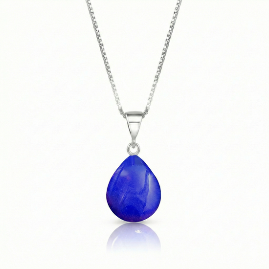 Our best selling crystal X-Small Drop Pendant is a beautiful, easy simple addition to any outfit. Handmade pendants come in a wide variety of colors and shine with an iridescent glow of color from within. Sterling silver .7mm box chain, 18" included with the polished violet pendant.