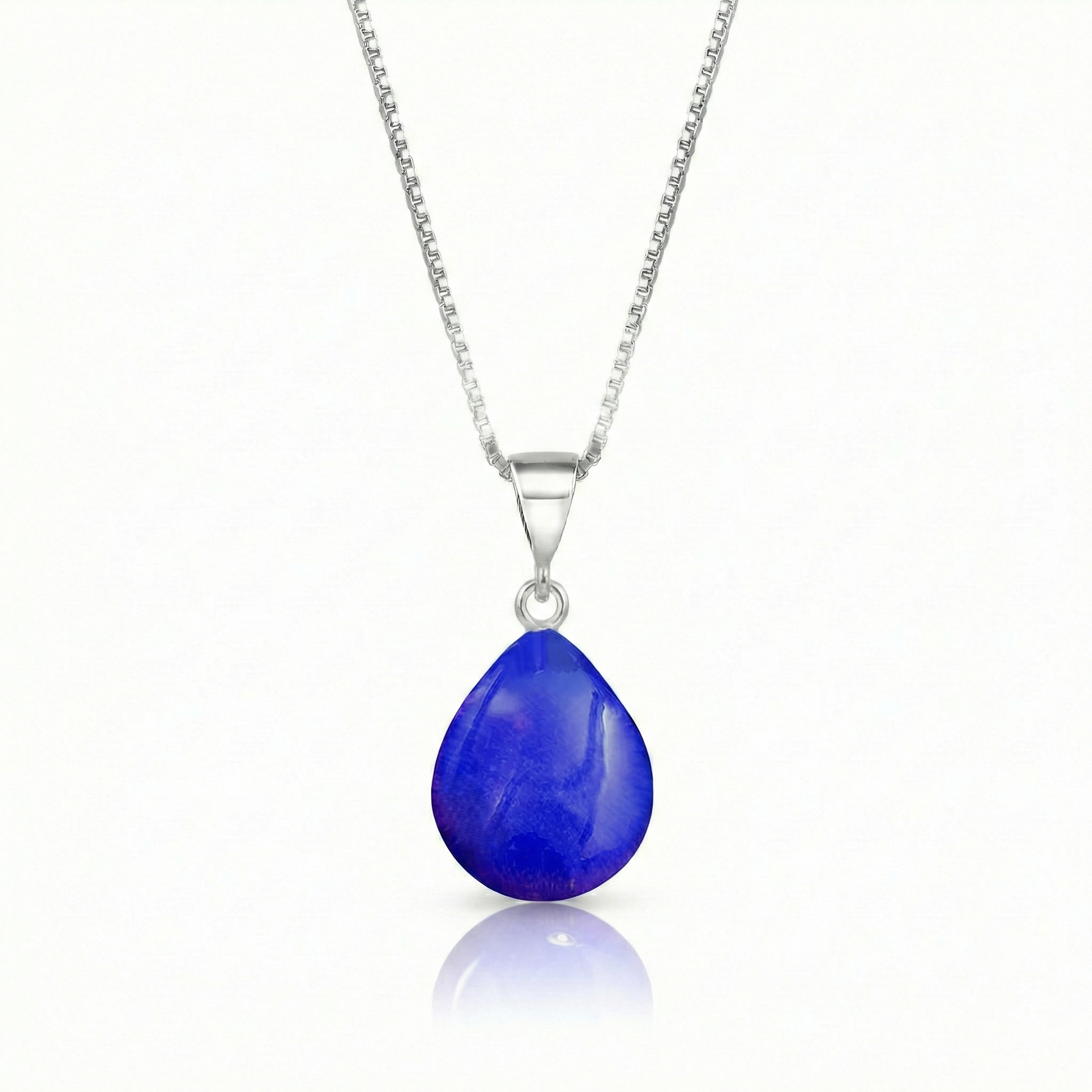Our best selling crystal X-Small Drop Pendant is a beautiful, easy simple addition to any outfit. Handmade pendants come in a wide variety of colors and shine with an iridescent glow of color from within. Sterling silver .7mm box chain, 18" included with the polished violet pendant.